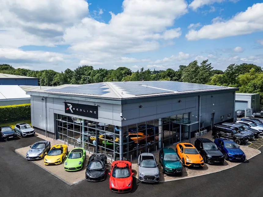 Aerial view of the Redline dealership with a colourful lineup of performance cars
