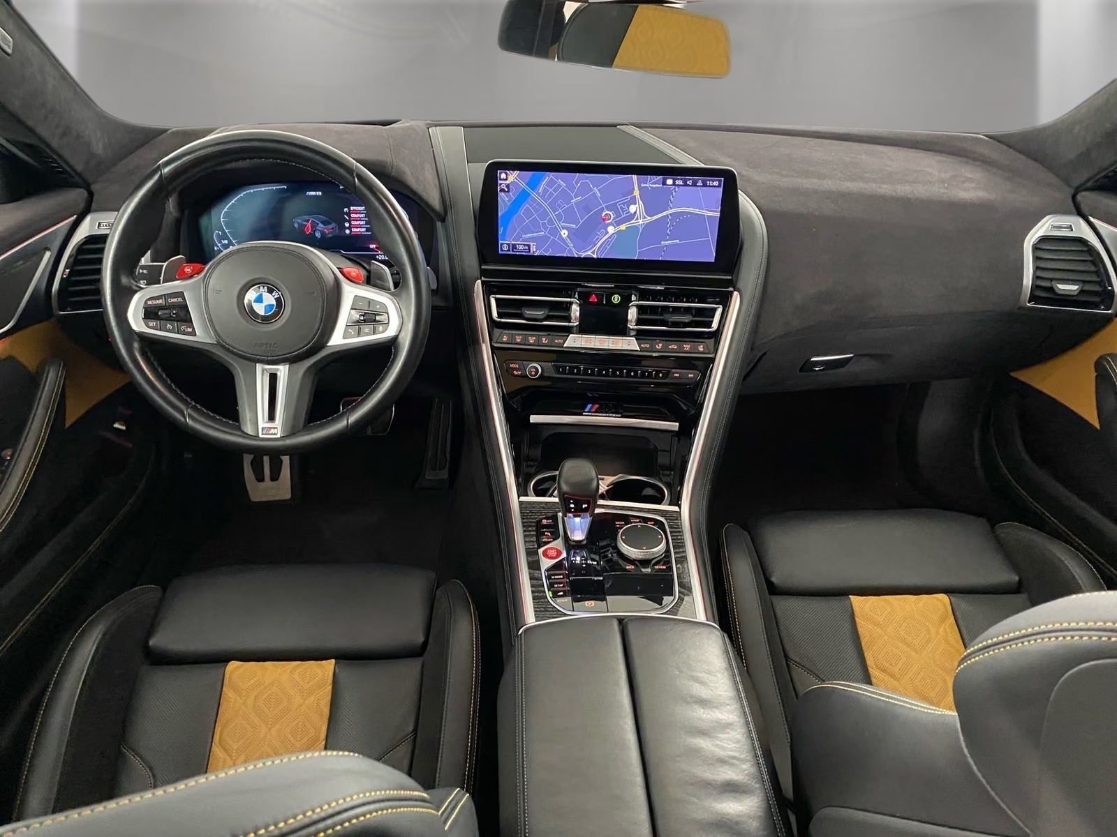 BMW M8 Competition Gran Coupé 2023 — cockpit with M steering wheel and Live Cockpit Professional