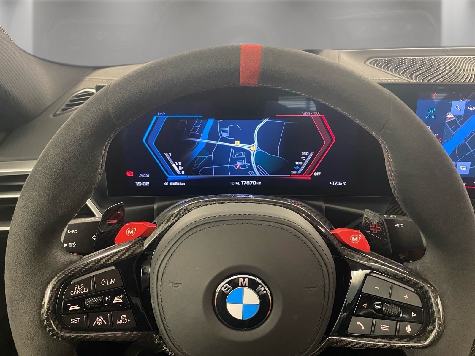 M Alcantara steering wheel with carbon trim and fully digital instrument cluster.