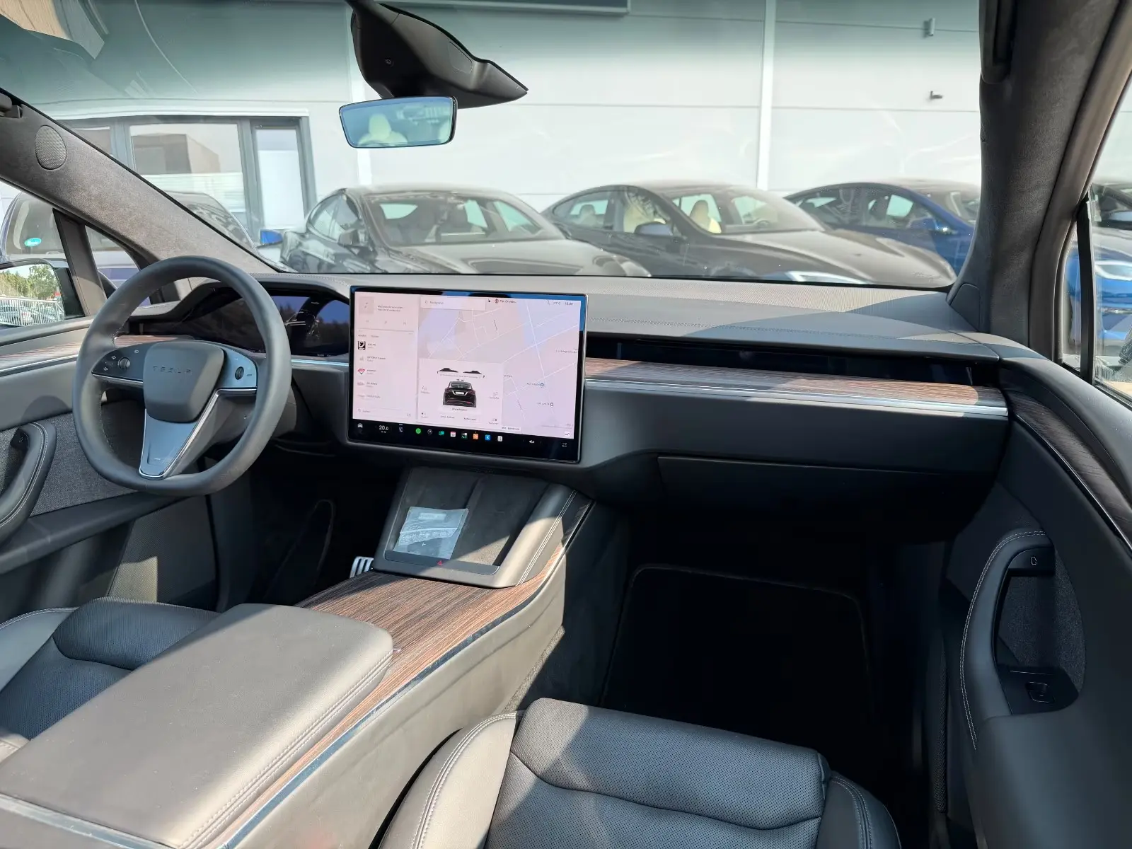 Tesla Model X dashboard with central touchscreen showing navigation.