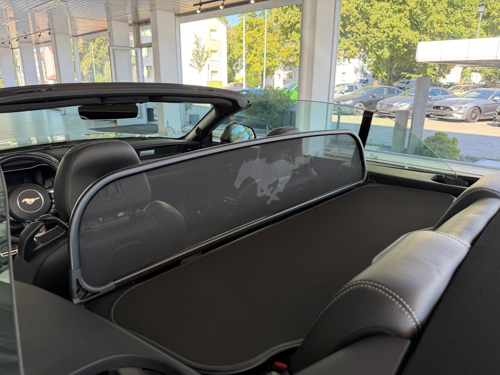 Ford Mustang GT Convertible rear cabin wind deflector with the Mustang emblem.