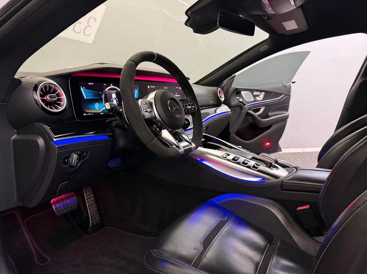 Mercedes-AMG GT 43 4MATIC+ 2020 — driver's cockpit with AMG steering wheel and ambient lighting