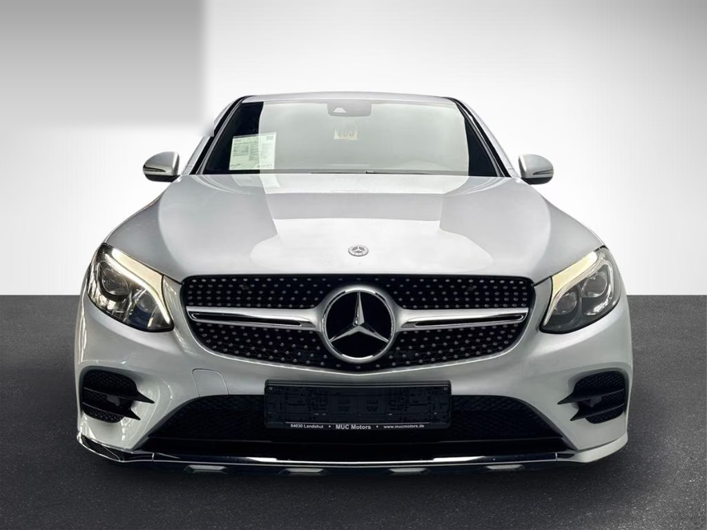 Front view of the silver Mercedes-Benz GLC 300 Coupé showing the diamond grille, star badge and LED headlights.