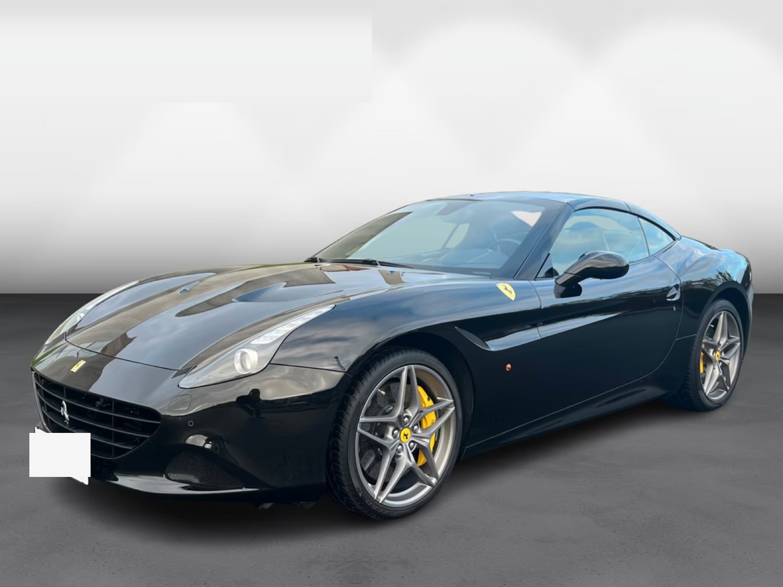 Ferrari California T in black, front three-quarter studio view