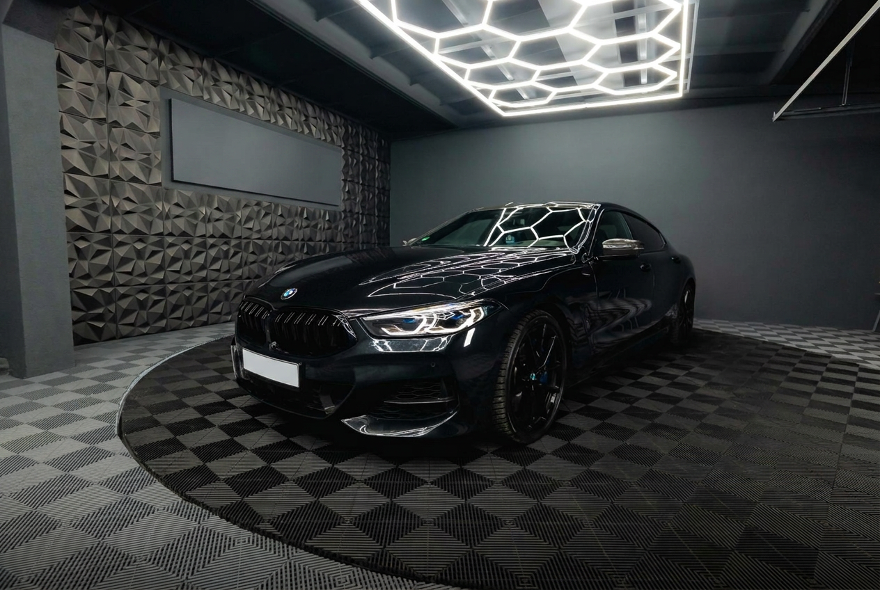 BMW M850i xDrive Gran Coupé in Carbon Black — front three-quarter view