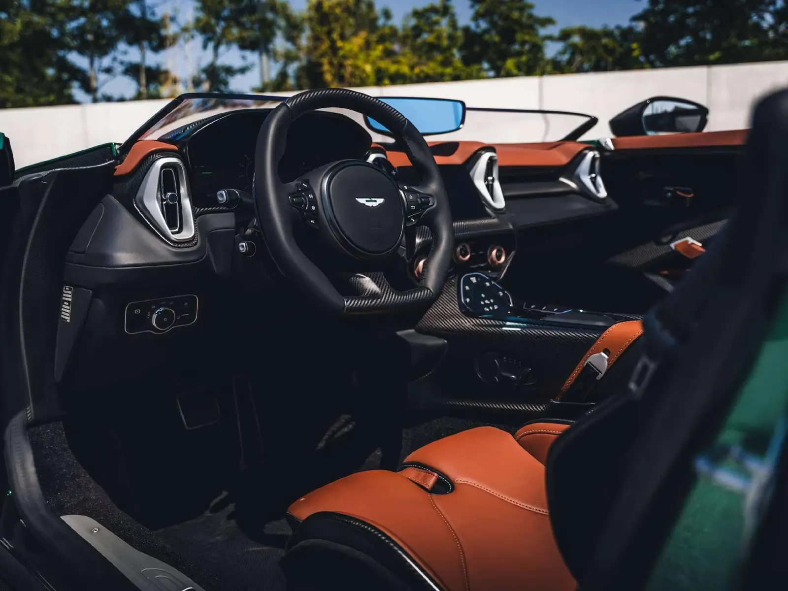 Cockpit of the Aston Martin DBR22 with carbon dashboard, black steering wheel and Chestnut Tan leather.
