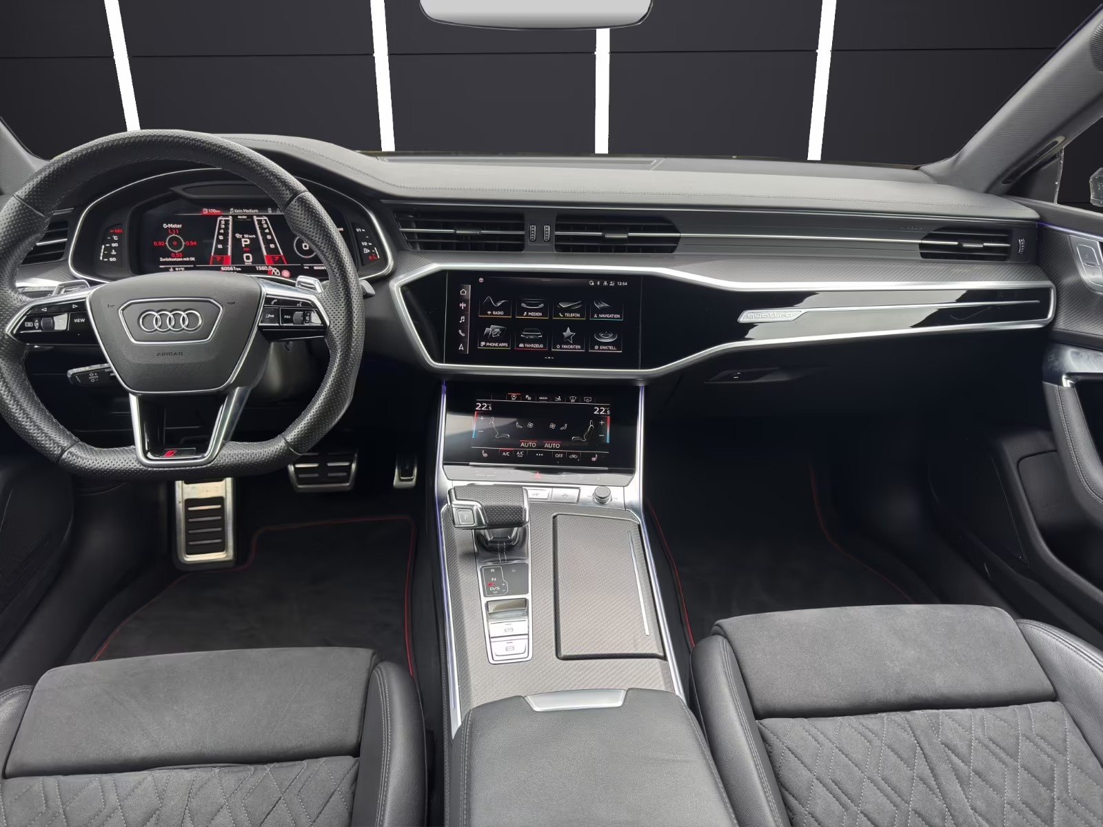 Front dashboard of the Audi RS7 showing the dual MMI touchscreens and carbon-look centre console.