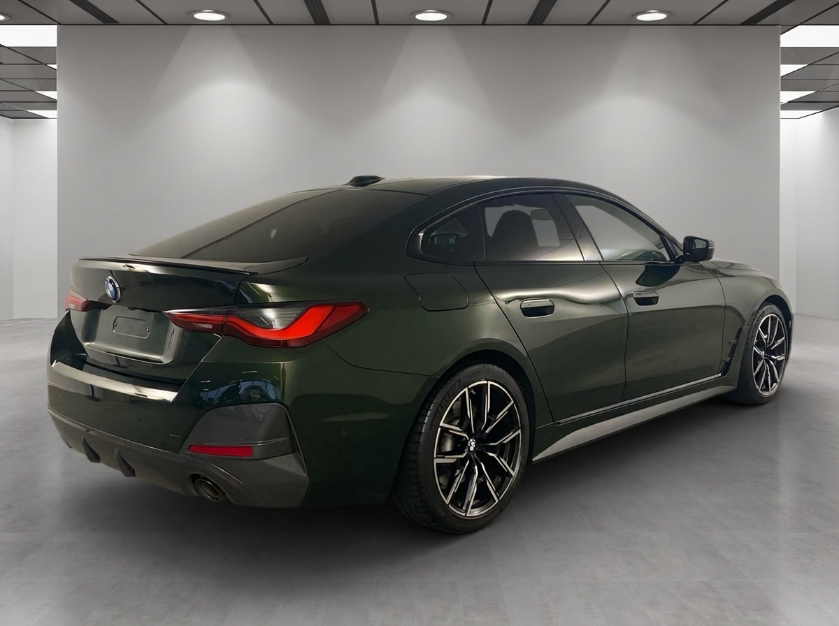 BMW 430i xDrive Gran Coupé 2023 — rear three-quarter view with M spoiler