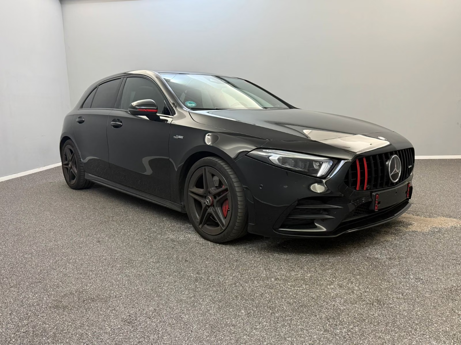 Mercedes-AMG A 35 4MATIC 2021 — side view with AMG wheels and red brake calipers