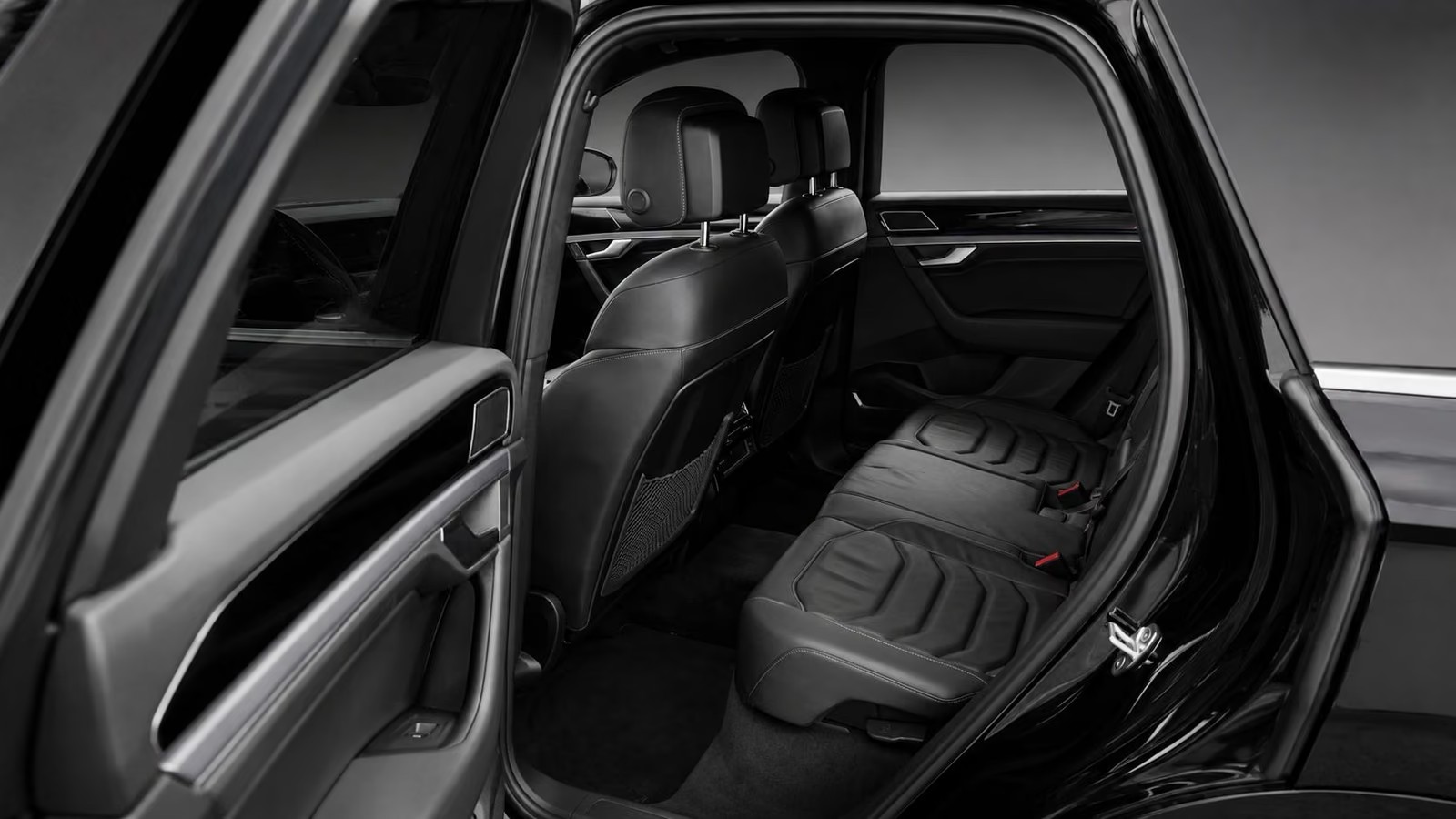 Rear seats of the Volkswagen Touareg in grey leather with the rear door open.