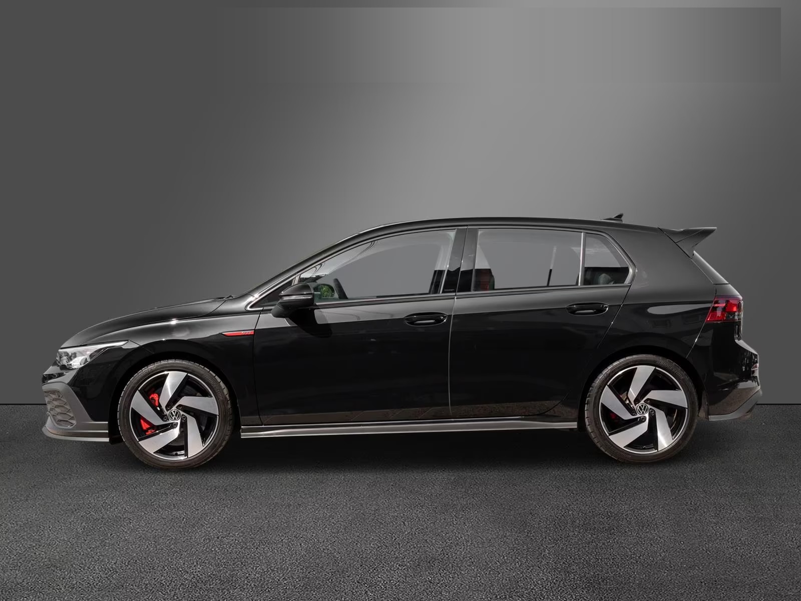Side profile of the black Golf GTI Clubsport with alloy wheels and red brake calipers.