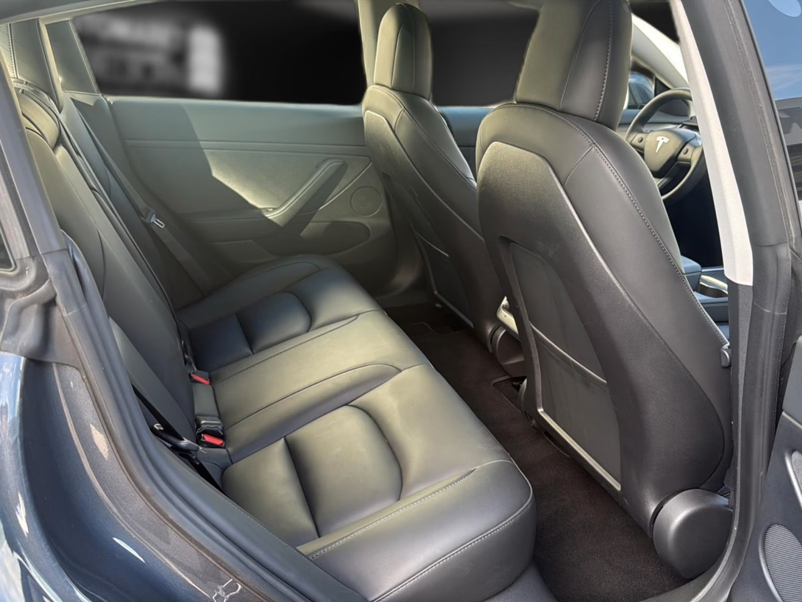 Black leather rear seats of the Tesla Model 3.