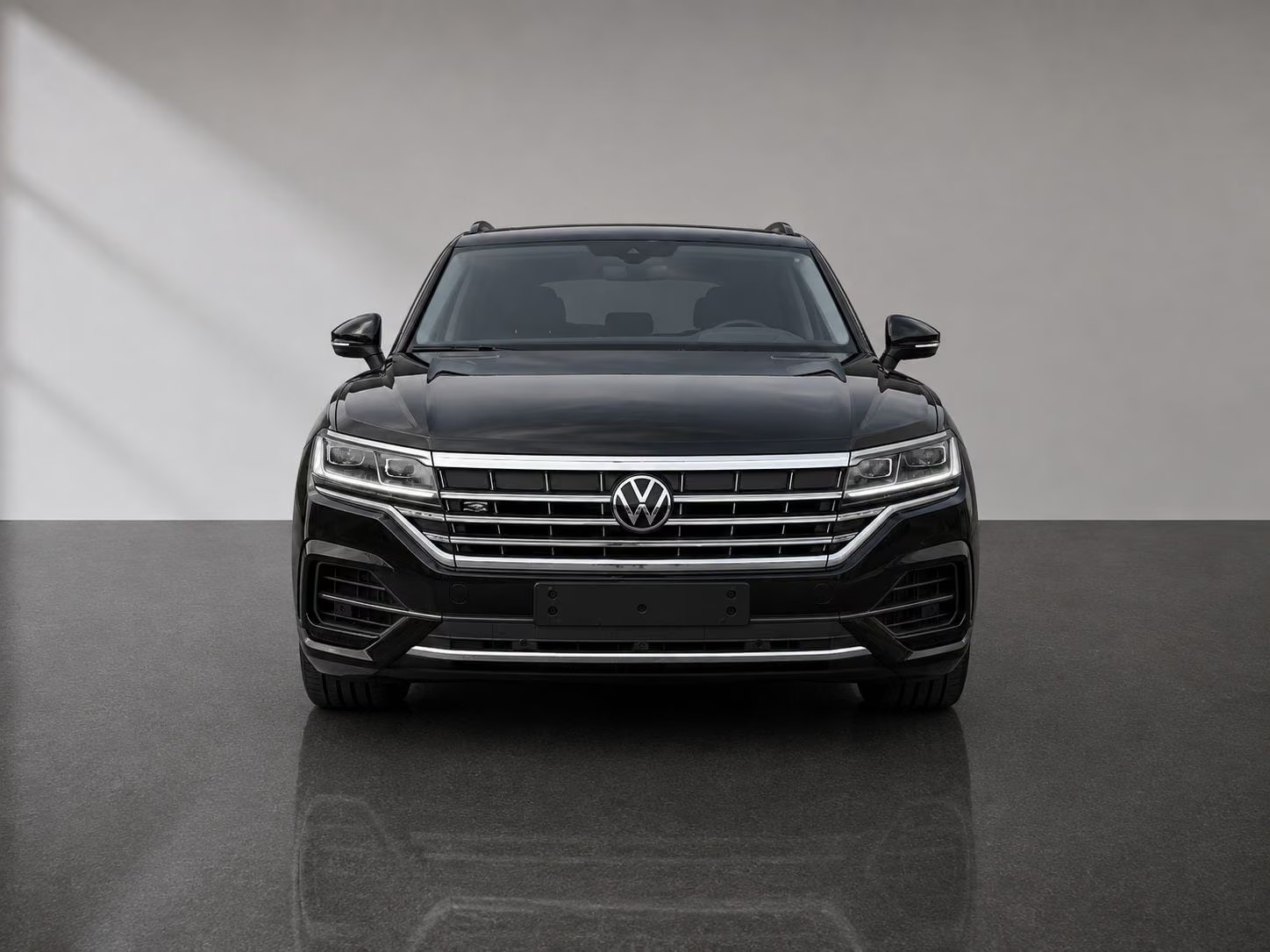 Head-on front view of the black Volkswagen Touareg showing the chrome grille and LED headlights.