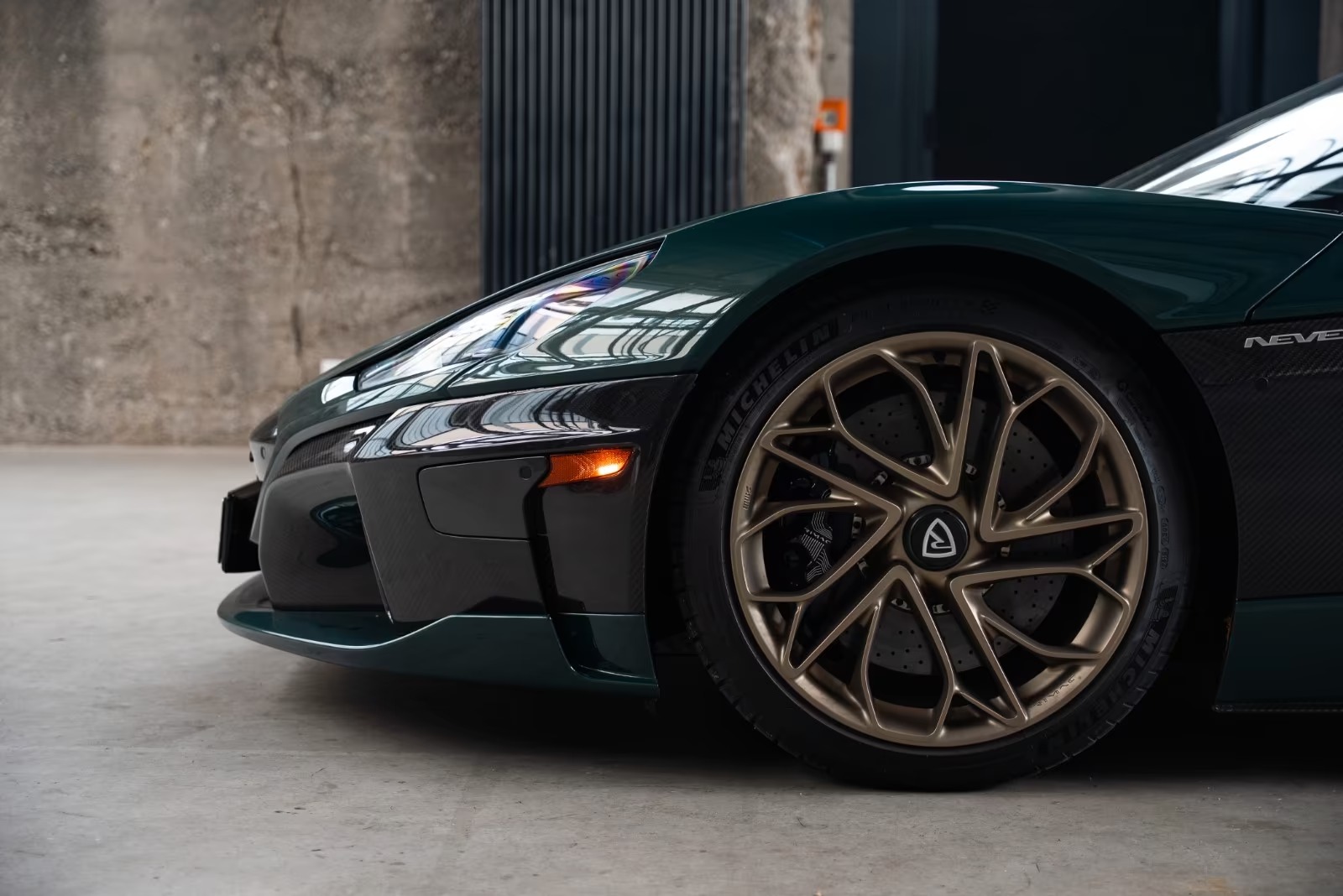 Close-up of the Rimac Nevera front wheel, bronze Infinitus rim and carbon ceramic brake.