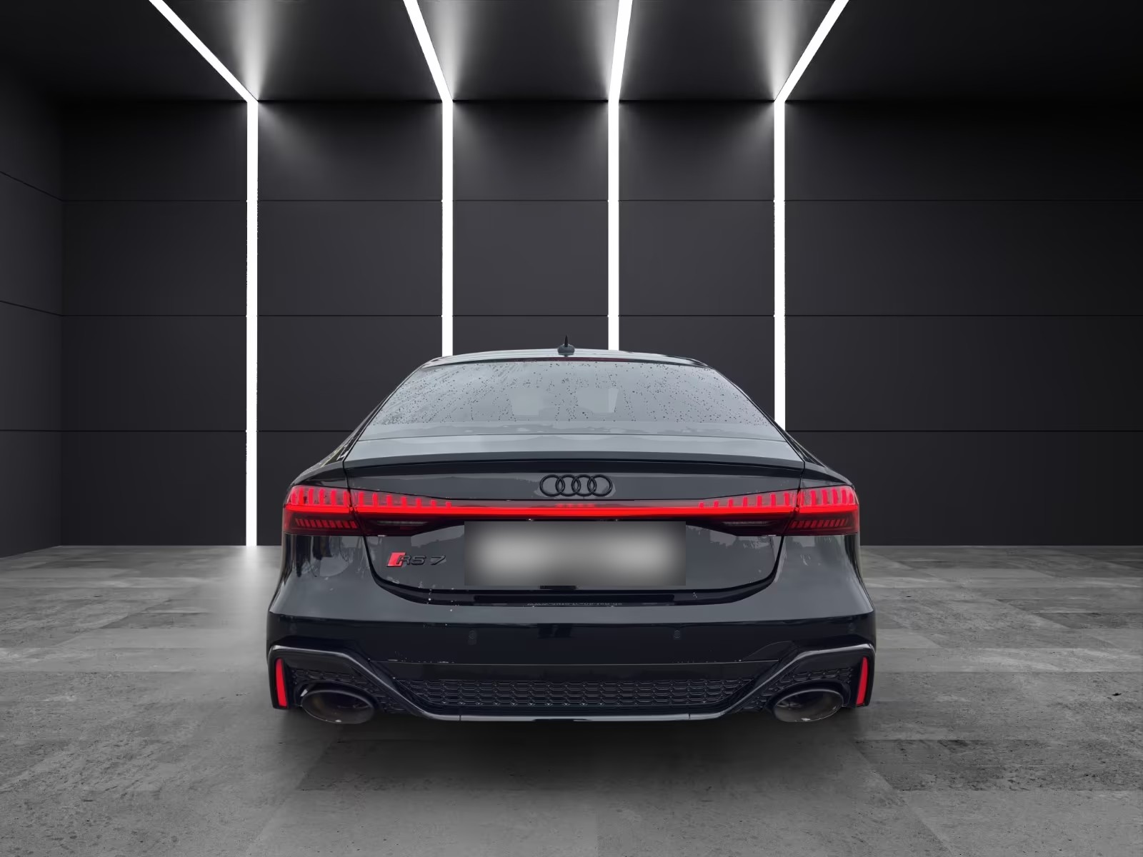 Rear view of the Audi RS7 Sportback with the full-width LED tail light bar and oval exhaust tips.
