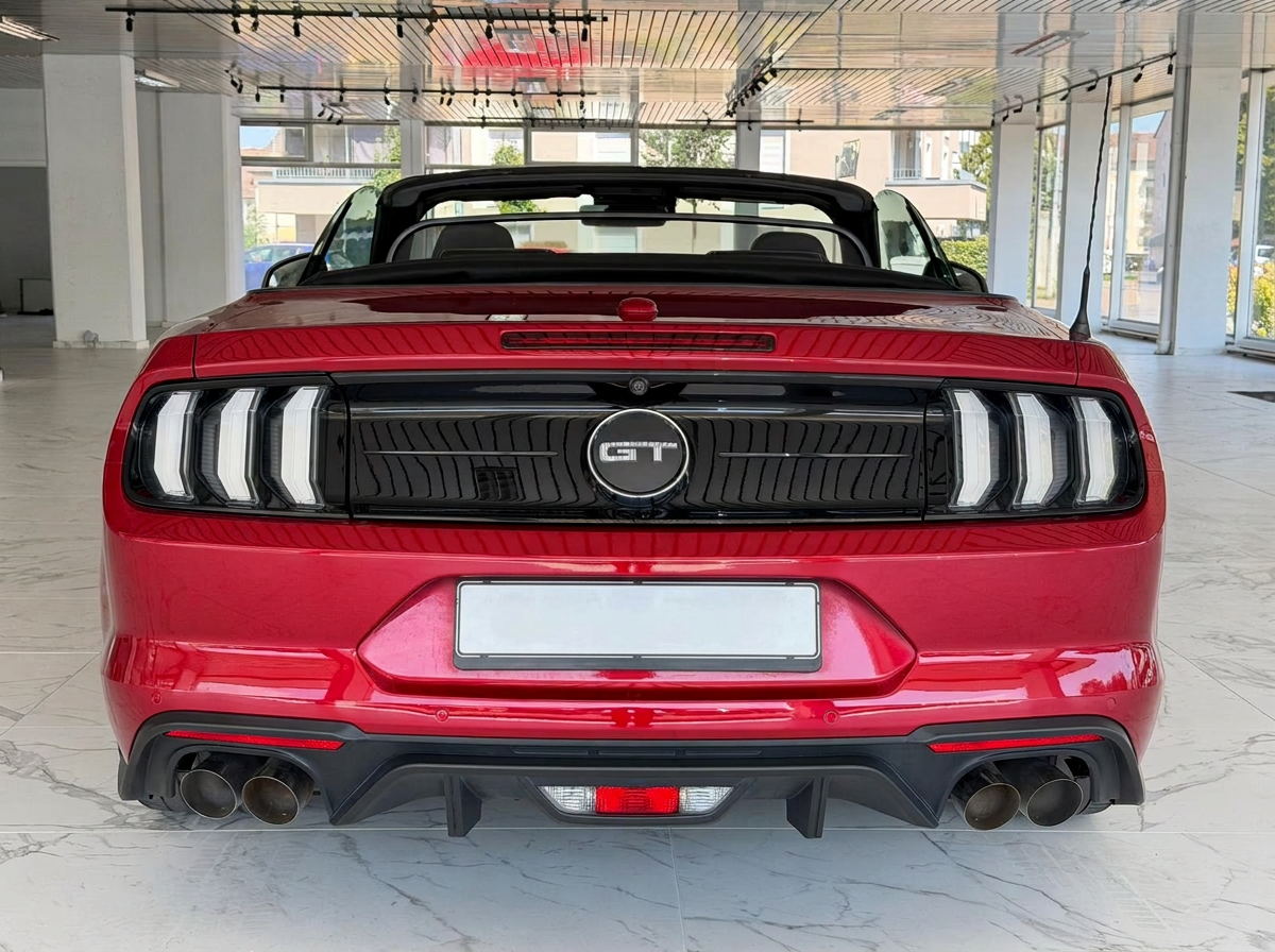 Rear view of the red Ford Mustang GT Convertible showing the GT badge, LED tail lights and quad exhausts.