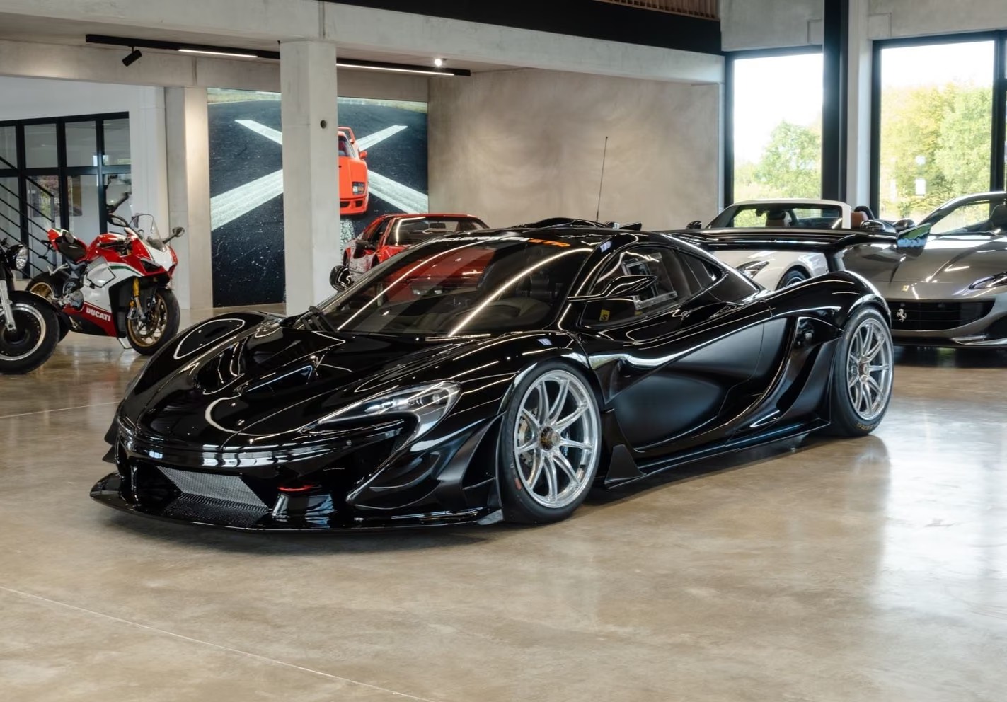 McLaren P1 GTR in Onyx Black, front three-quarter view in a showroom.