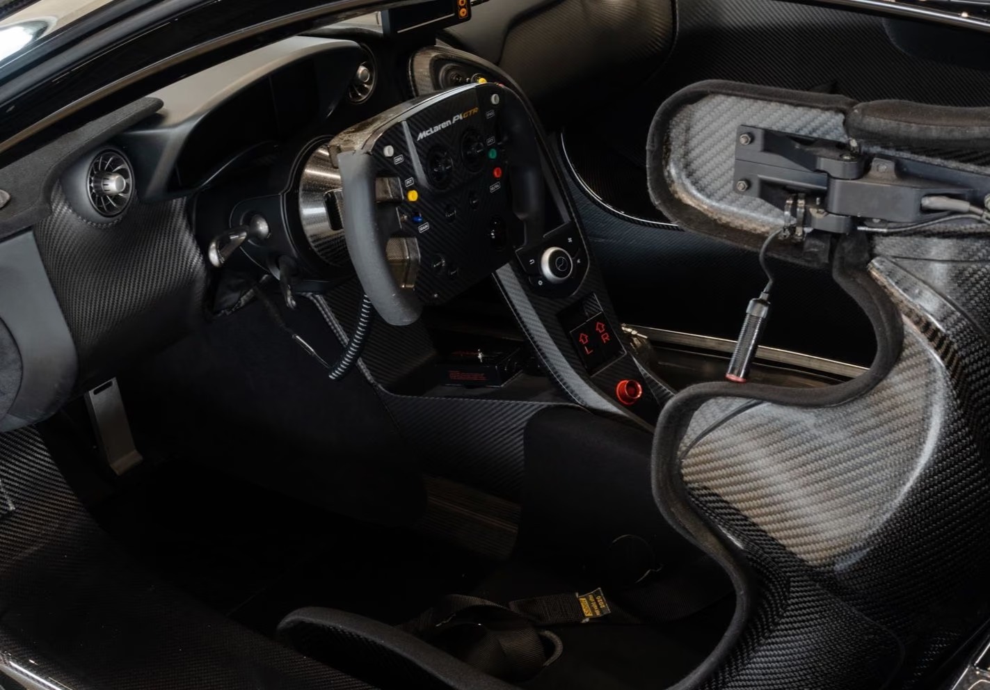Interior of the McLaren P1 GTR showing the carbon dashboard and Formula 1-derived steering wheel.