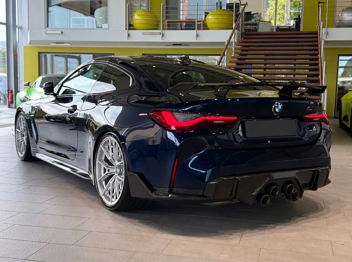 BMW M4 Competition — rear three-quarter view with carbon wing and diffuser