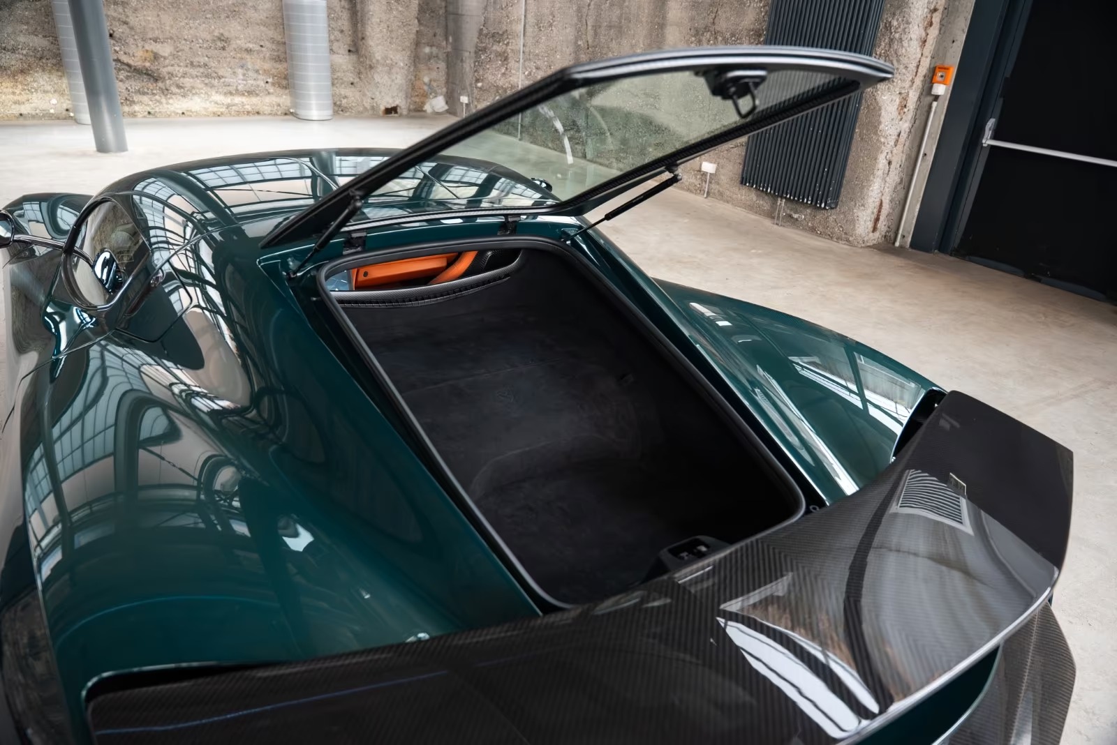 Open rear luggage compartment of the Rimac Nevera under the glass hatch.