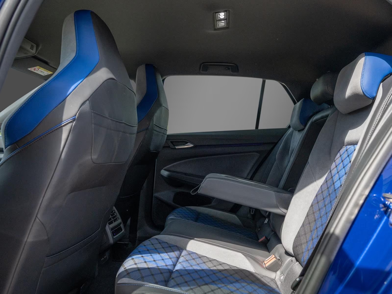 Rear passenger compartment of the Golf R with matching blue tartan upholstery.