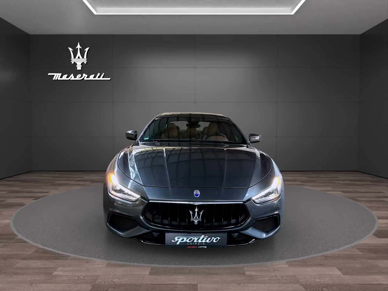 Front view of the Maserati Ghibli S Q4 with LED headlights illuminated.
