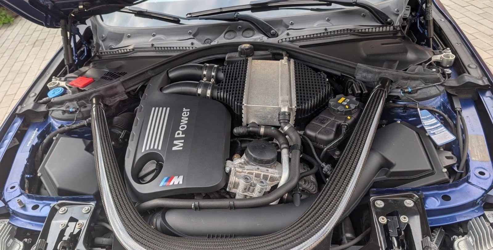 Engine bay of the BMW M4 showing the M Power twin-turbo straight-six.