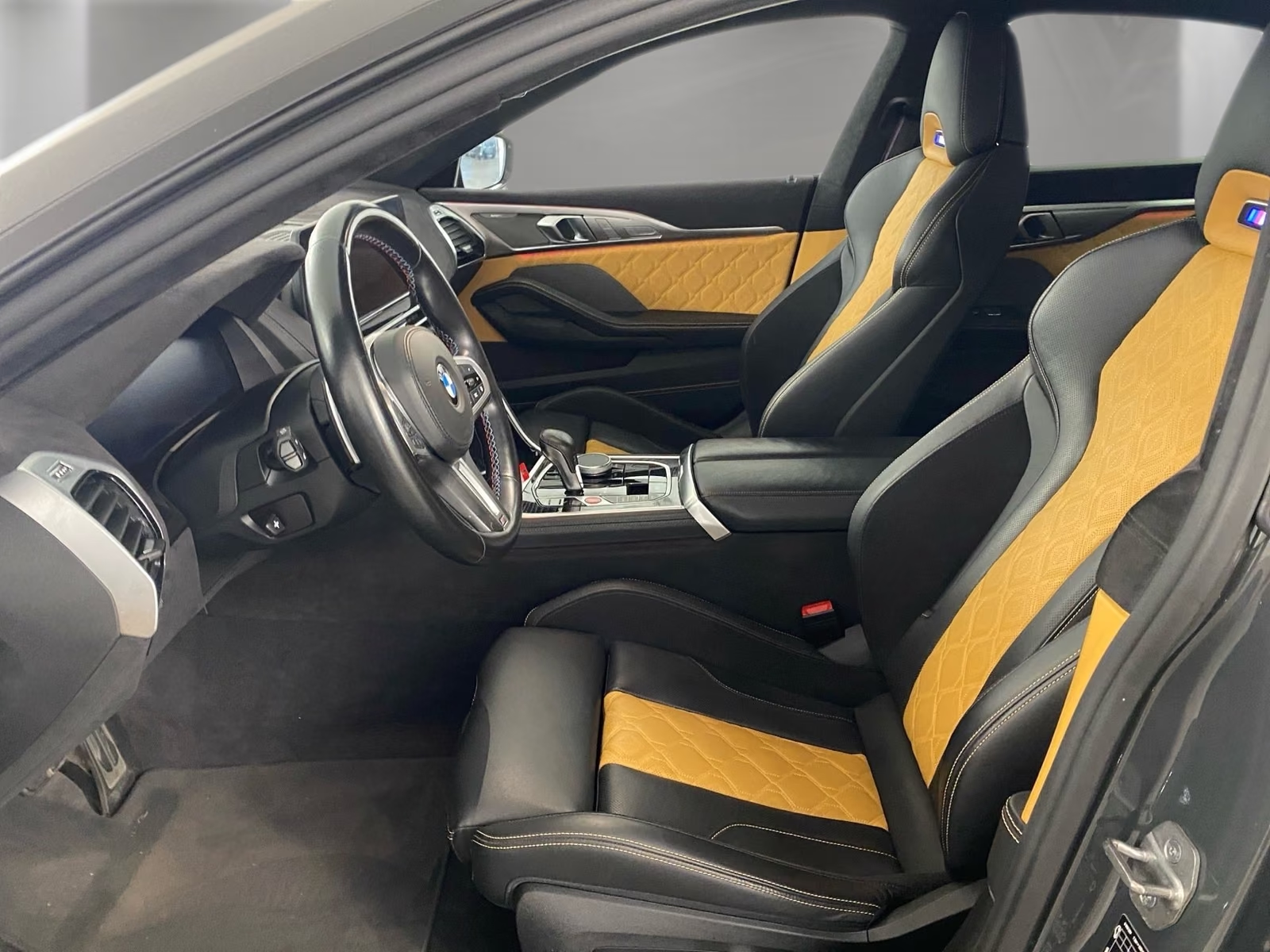 BMW M8 Competition Gran Coupé 2023 — black and Midrand Beige Merino leather interior