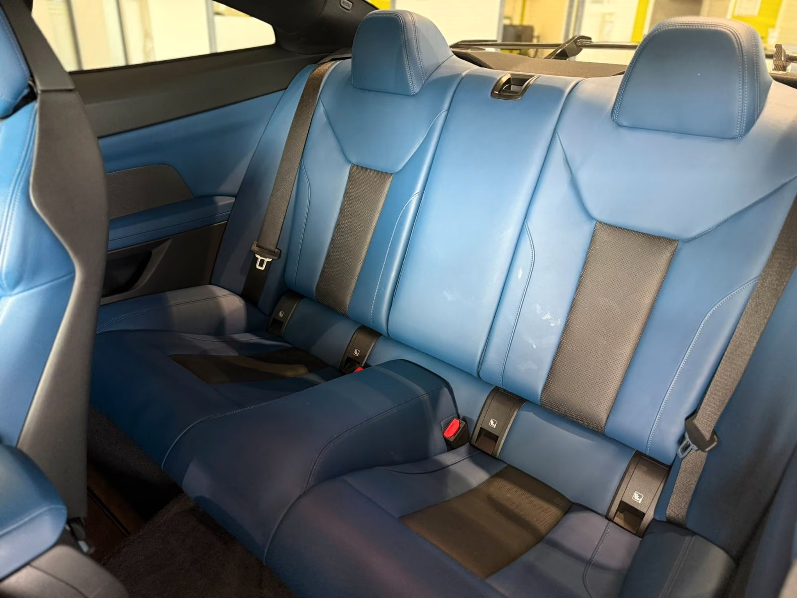BMW M4 Competition — Fjord Blue and black rear seats