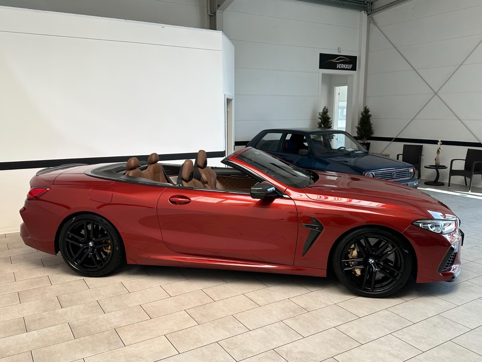 Side profile of the BMW M8 Competition Cabrio with the soft top folded away.