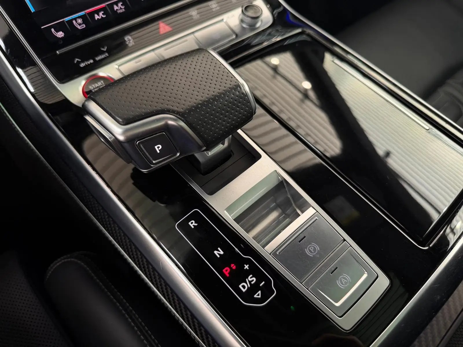 Close-up of the Audi RS Q8 gear selector and centre console with carbon trim.