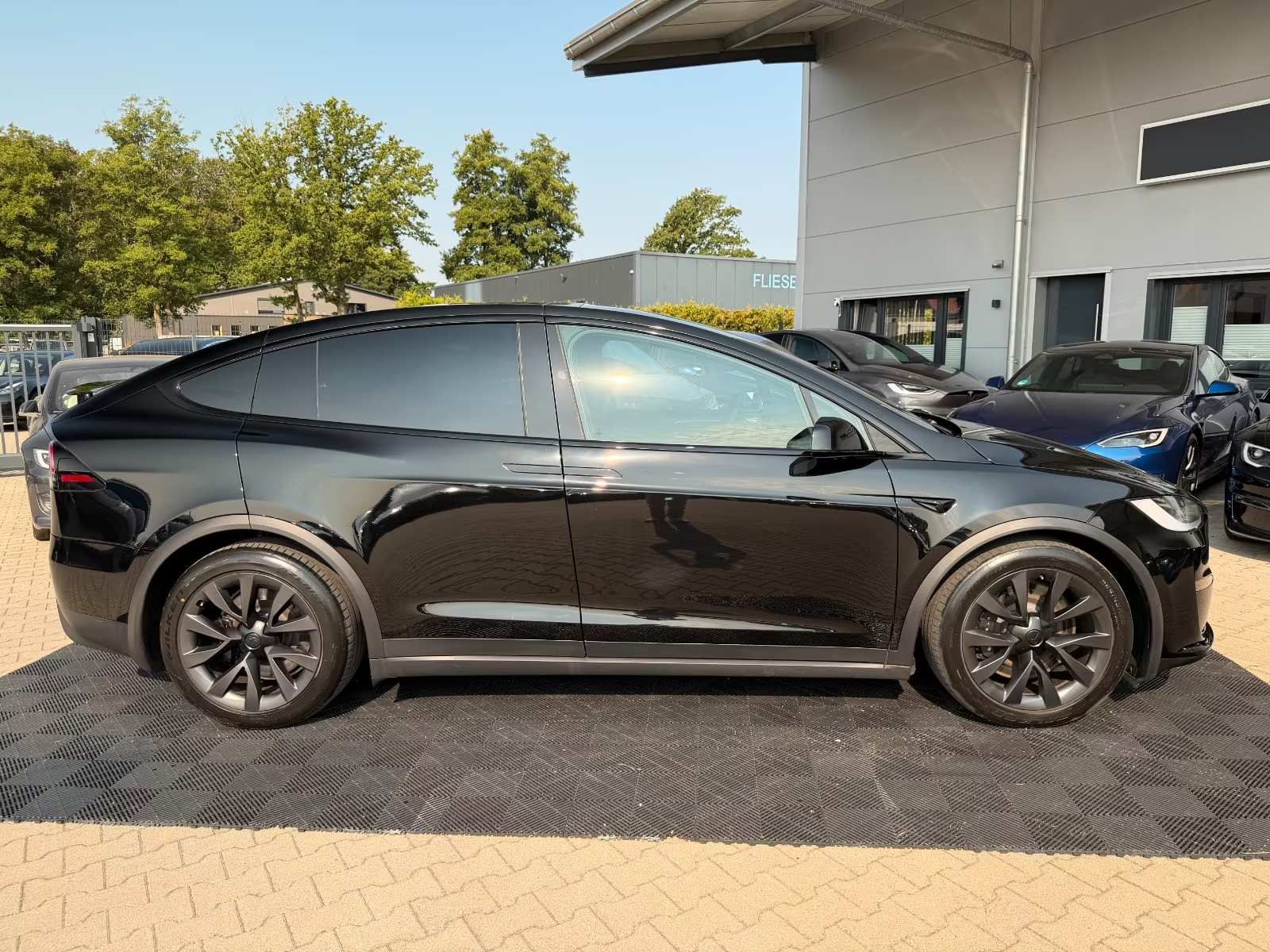 Side profile of the black Tesla Model X Long Range with tinted windows.
