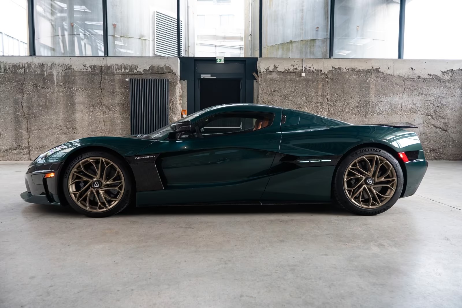 Side profile of the green Rimac Nevera on bronze Infinitus wheels.