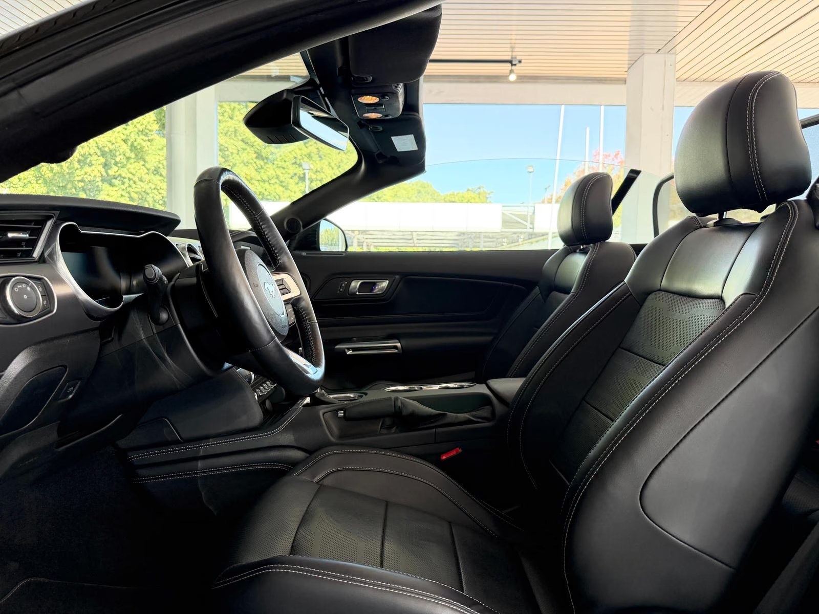 Passenger-side view across the black leather interior of the Ford Mustang GT Convertible.