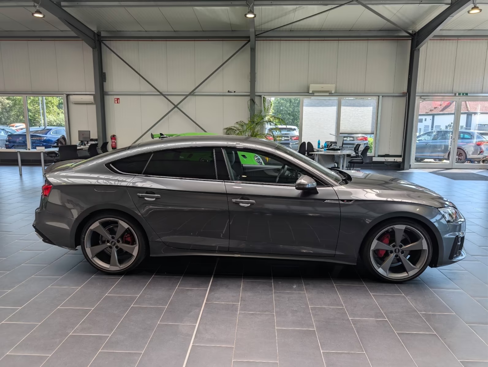 Full side profile of the Audi A5 Sportback showing the five-door bodystyle, doors, mirrors and five-spoke alloy wheels.