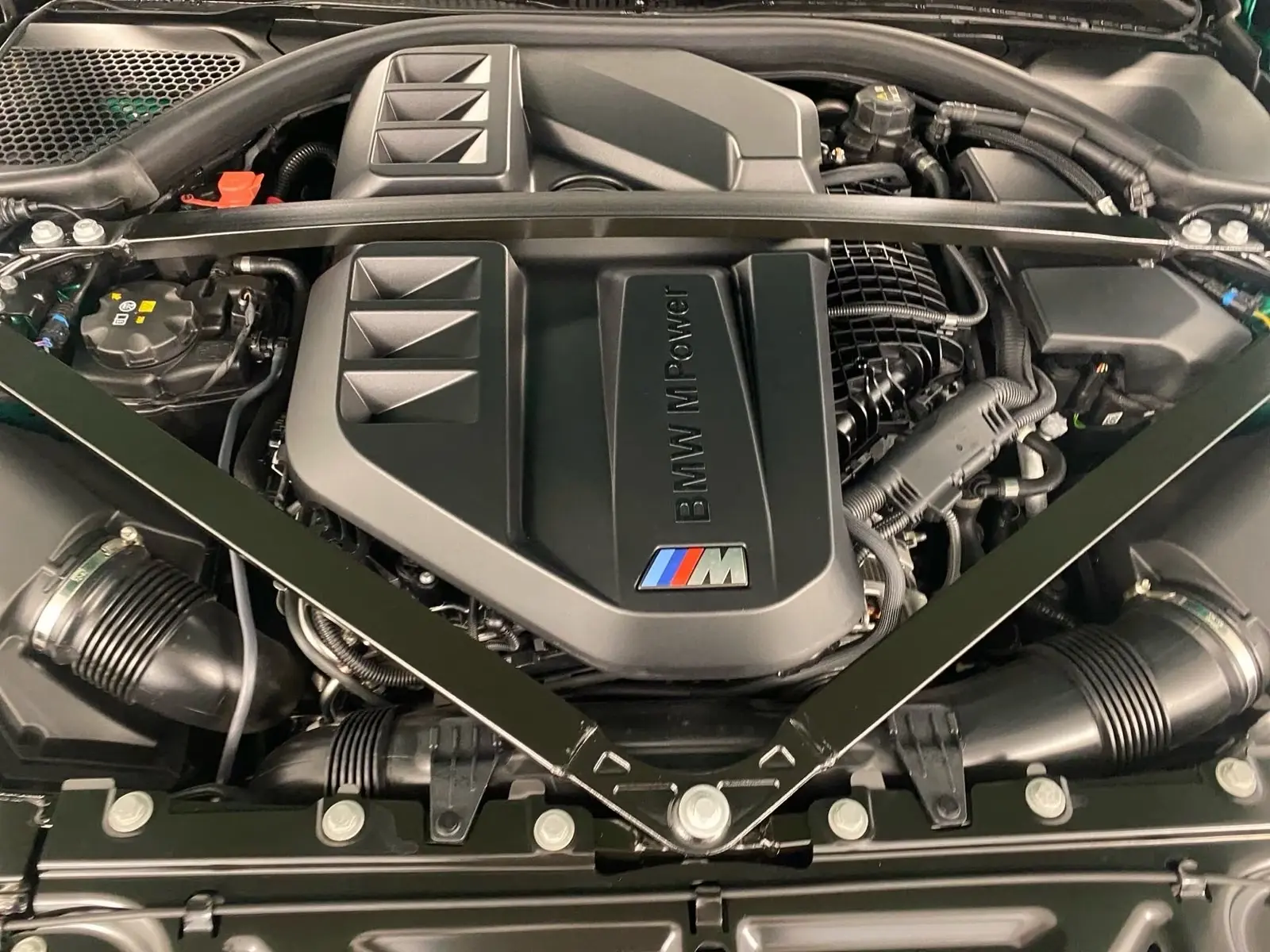 Engine bay of the BMW M4 showing the M TwinPower Turbo straight-six.