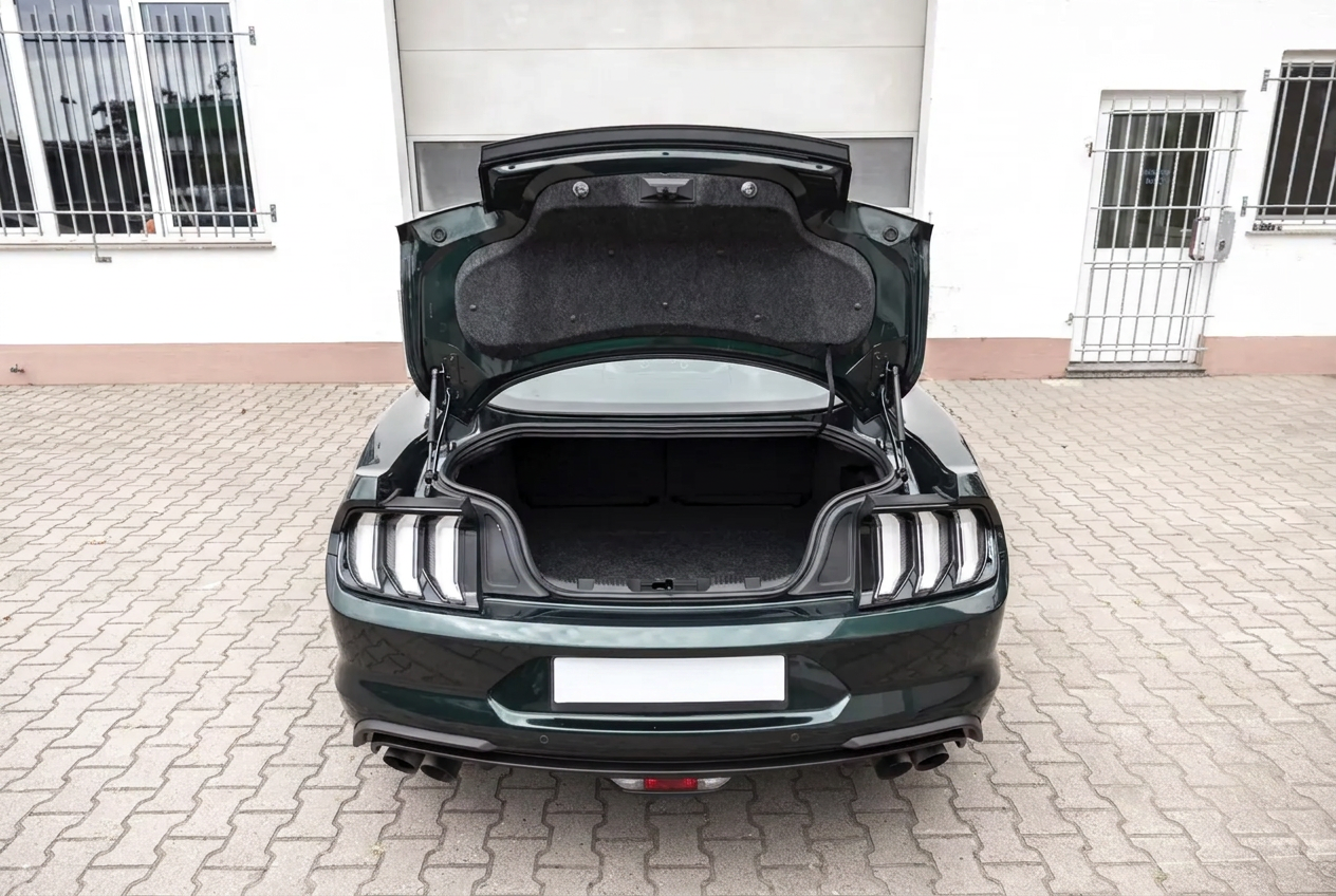 Rear view of the Ford Mustang Bullitt with the boot open showing the luggage compartment.