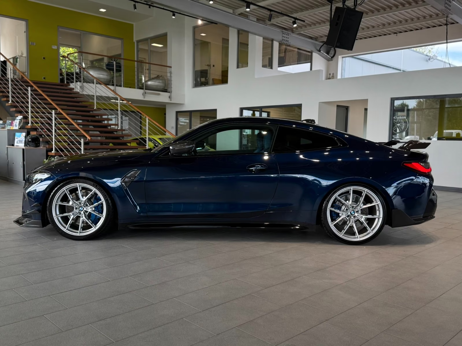 BMW M4 Competition in Tanzanite Blue — side profile
