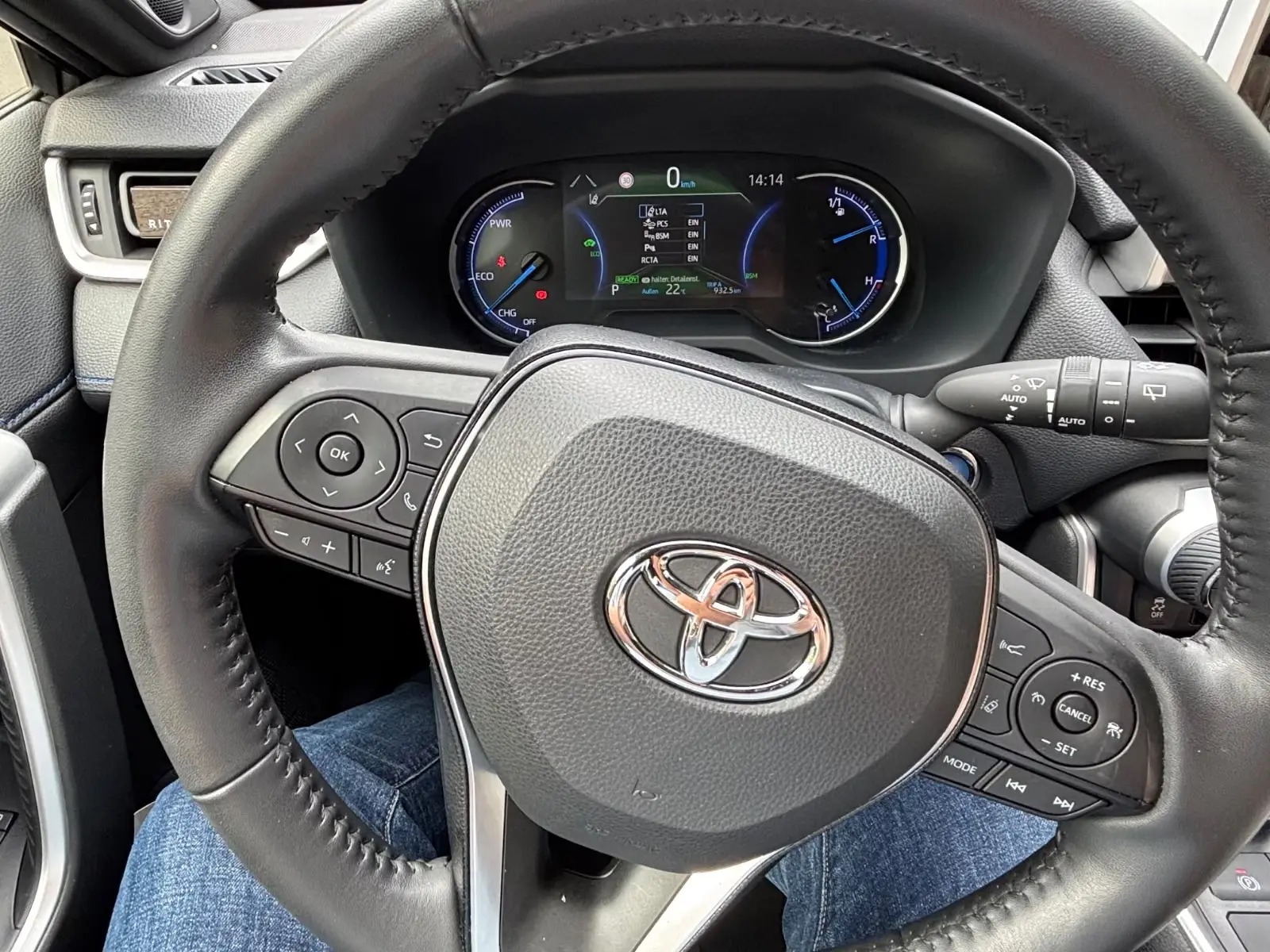 Steering wheel and digital instrument cluster of the Toyota RAV4 Hybrid.