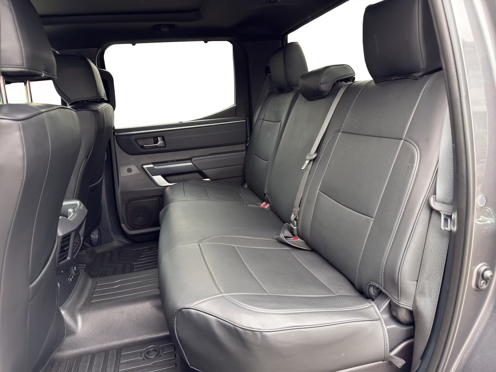 Rear black leather seats of the Toyota Tundra CrewMax.