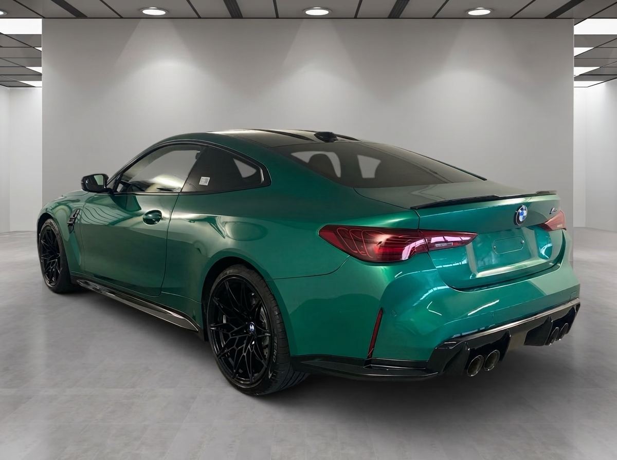 Rear view of the BMW M4 Coupé with black M forged wheels.