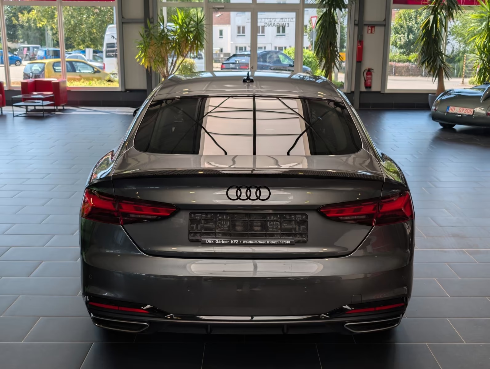 Rear view of the Audi A5 Sportback showing the tailgate, rear lights, twin exhaust outlets and rear diffuser.