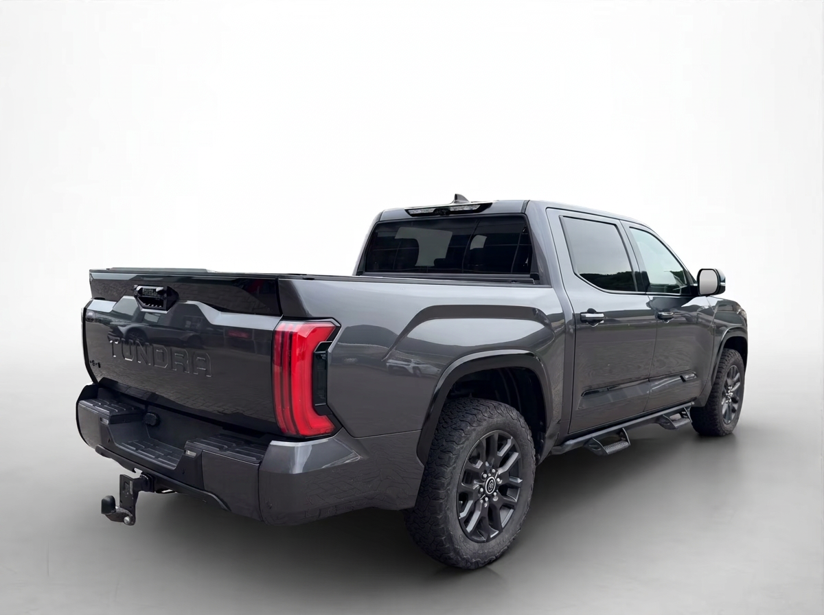 Rear three-quarter view of the Toyota Tundra with embossed TUNDRA tailgate.