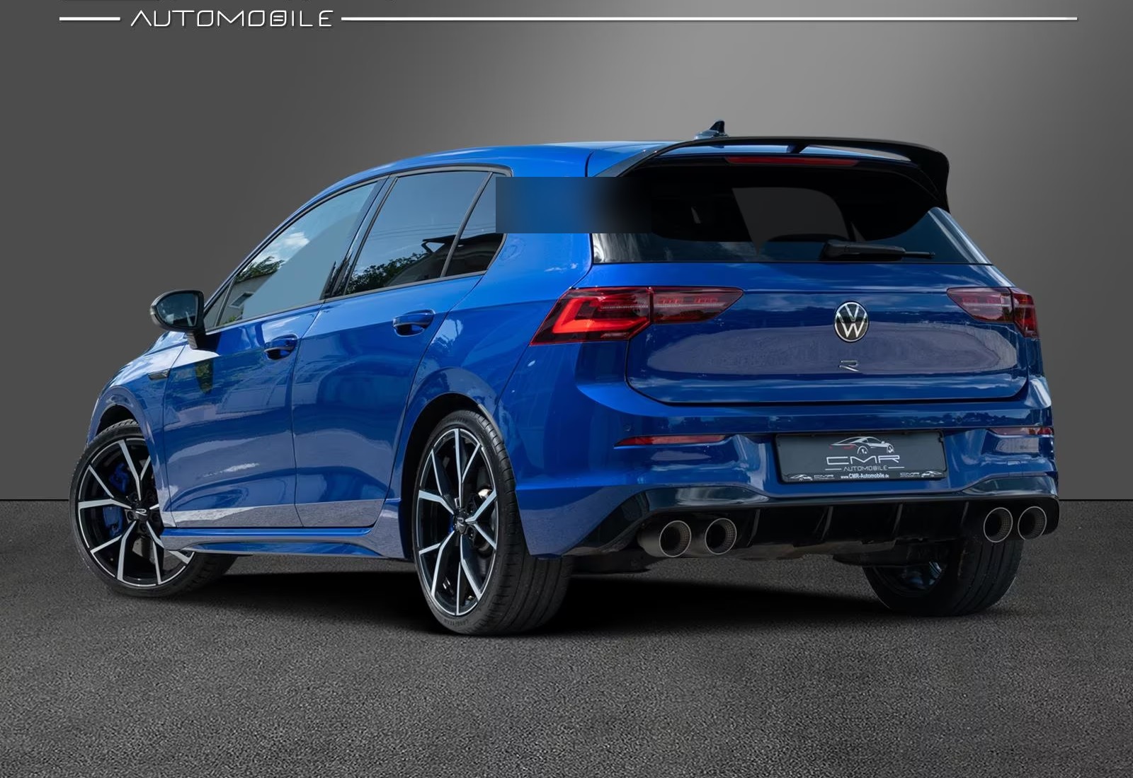 Rear three-quarter view of the blue Volkswagen Golf R showing its quad exhaust outlets.