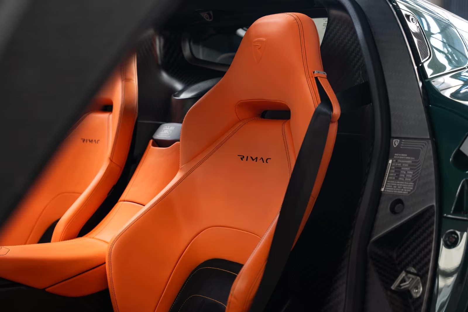 Track Orange leather sport seats with Rimac embroidery inside the Nevera.