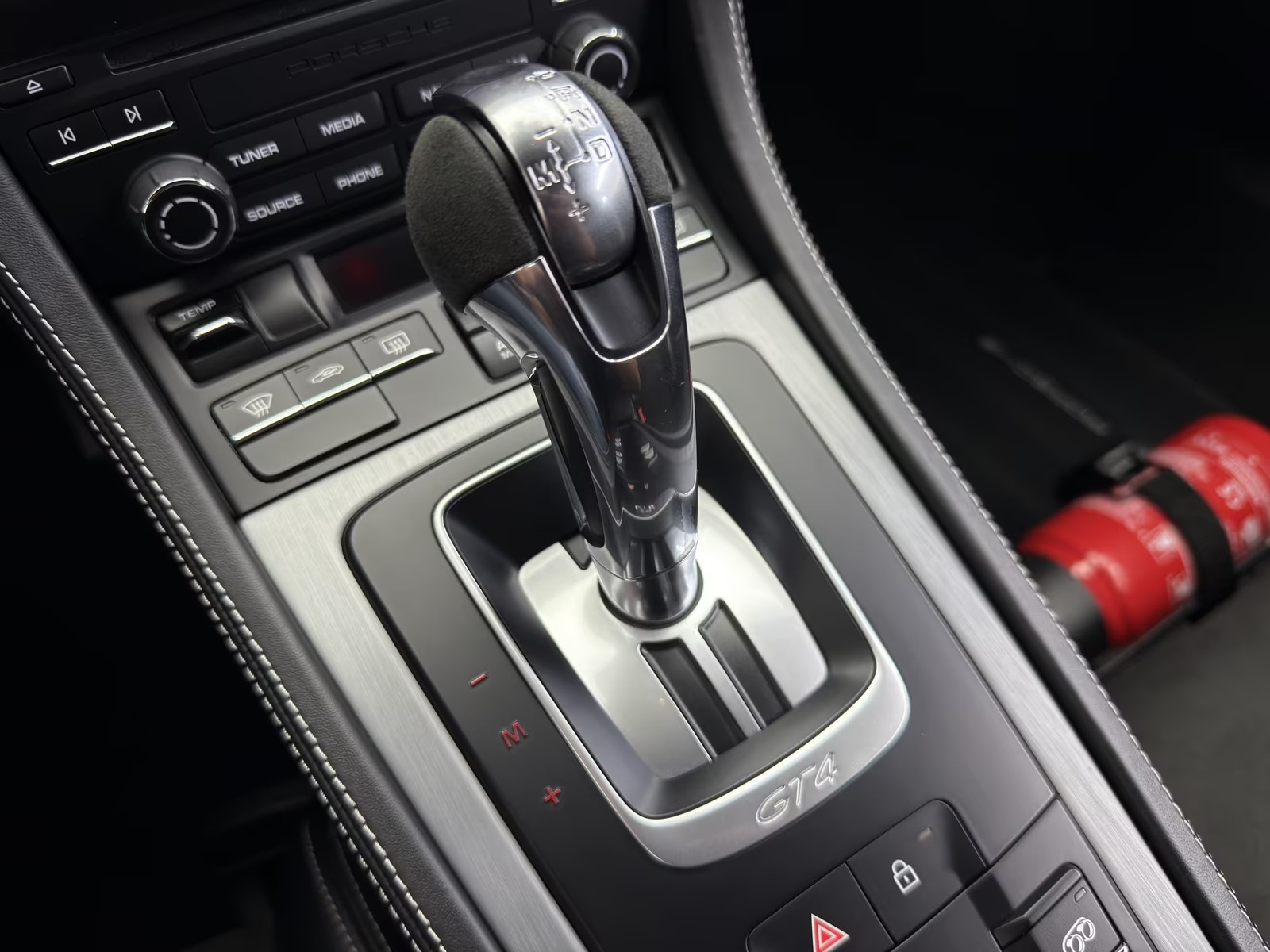 Centre console of the Porsche 718 Cayman GT4 showing the PDK selector lever with Alcantara grip and the GT4 badge.
