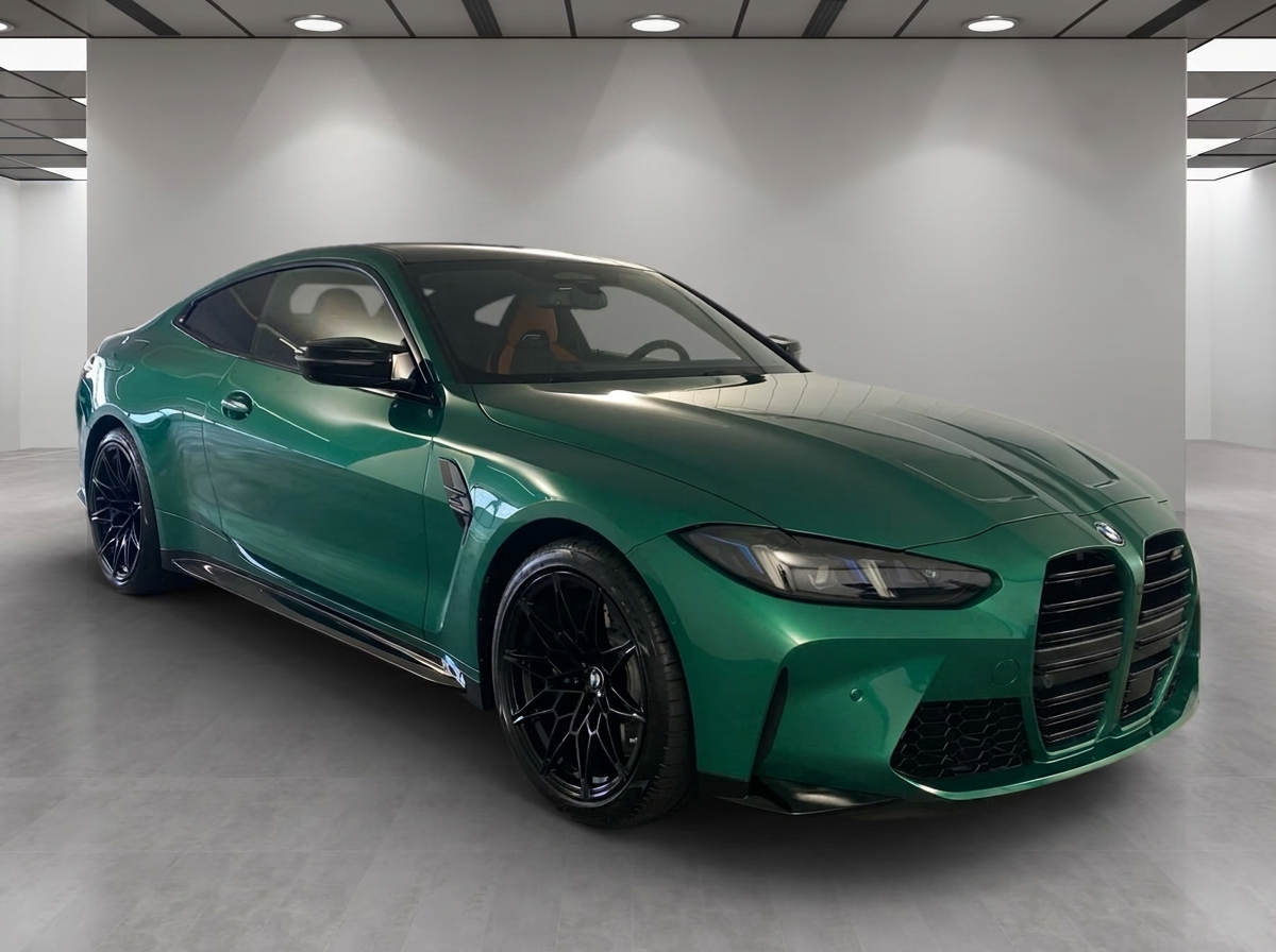BMW M4 xDrive Coupé in M Isle of Man Green, front three-quarter view.