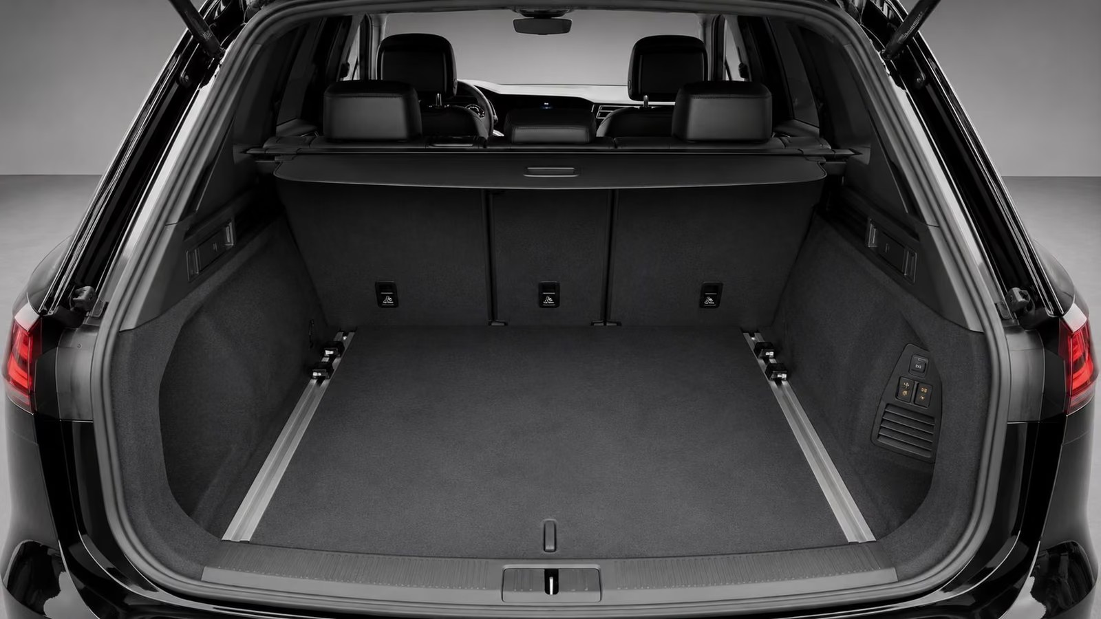 Open boot of the Volkswagen Touareg showing the carpeted luggage compartment and load rails.