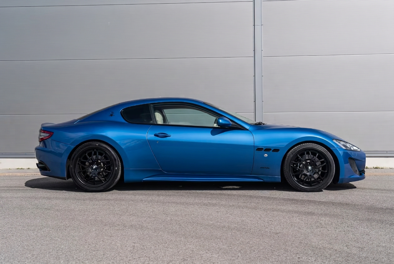 Side profile of the blue Maserati GranTurismo Sport coupe.