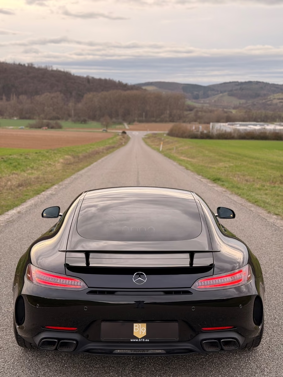 Rear view of the Mercedes-AMG GT C Coupé showing the wide rear track, tail lights and diffuser.